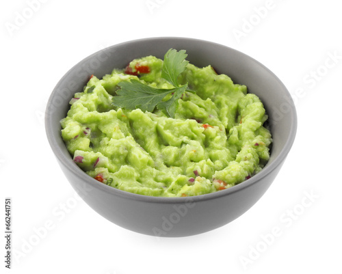 Bowl of delicious guacamole with parsley isolated on white