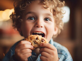 Close up portrait of a happy toddler kid eating a fresh baked cookie, blurred background