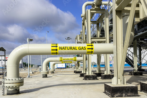 A row of pipes on a gas transport installation with the inscription natural gas
