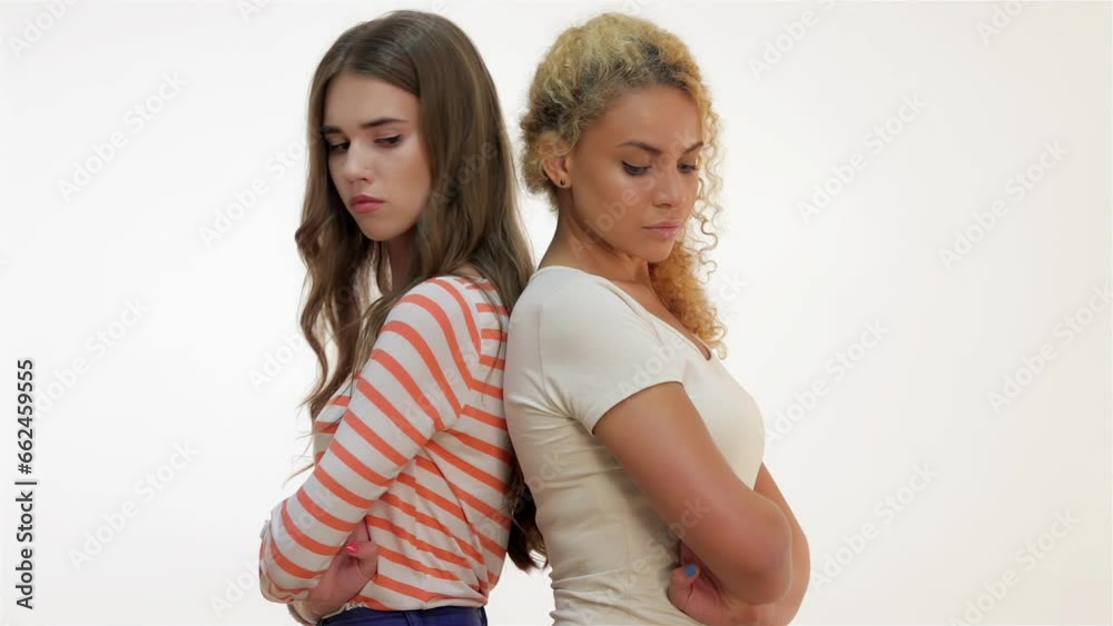 Girls quarreled and stand backs to each other Girls quarreled and stand backs to each other