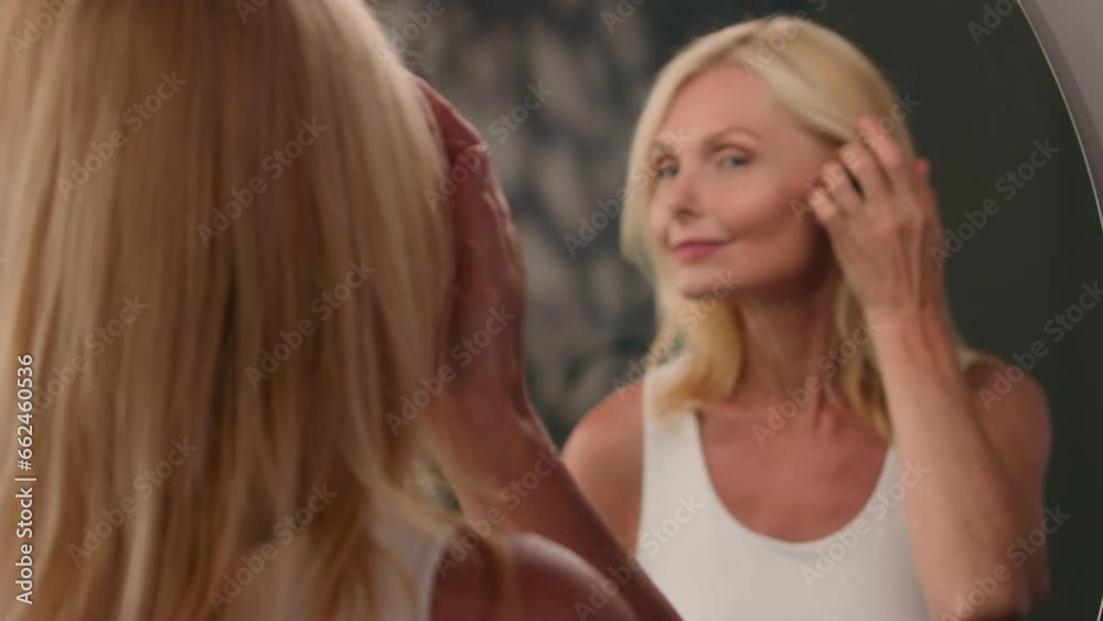 Mirror reflection Caucasian old middle-aged 50s senior woman beautiful mature female in bathroom smiling lady preparing morning bath beauty routine natural makeup anti-aging luxury cosmetics haircare Mirror reflection Caucasian old middle-aged 50s senior woman beautiful mature female in bathroom smiling lady preparing morning bath beauty routine natural makeup anti-aging luxury cosmetics haircare