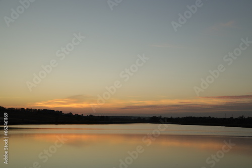 Fototapeta Naklejka Na Ścianę i Meble -  Beautiful sunset by the lake in a countryside