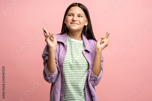 Canvas Print Teenage girl smiling dreaming with fingers crossed