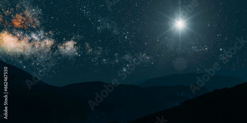 a Christmas star shines at night over the mountains of Bethlehem