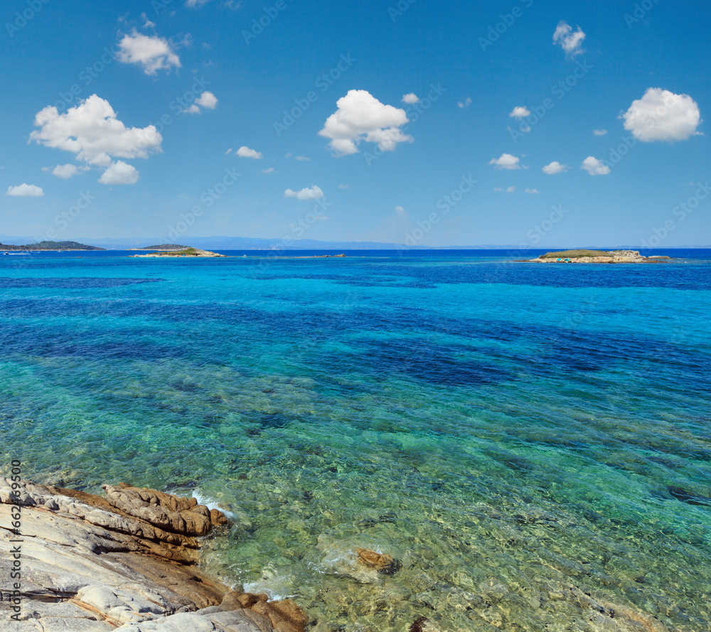 Aegean sea coast landscape with rocky island, view near Karidi beach (Chalkidiki, Greece).