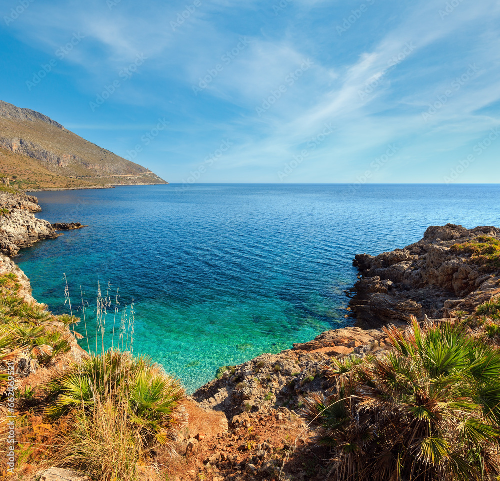 Paradise sea bay with azure water and beach view from coastline trail of Zingaro Nature Reserve Park, between San Vito lo Capo and Scopello, Trapani province, Sicily, Italy. Two shots stitch image.