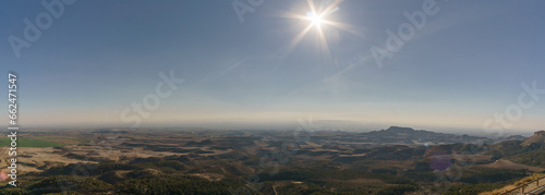 View of the Bardena Negra or Bardena black desert landscape of Bardenas Reales with vegetation, Navarra, Spain photo