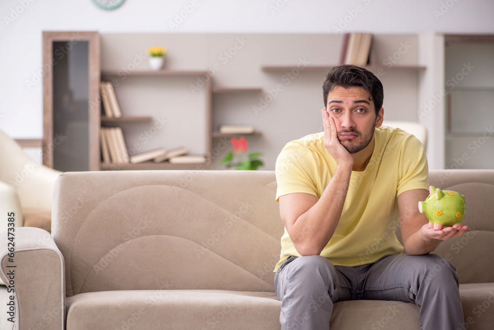 Young man in unemployment concept at home