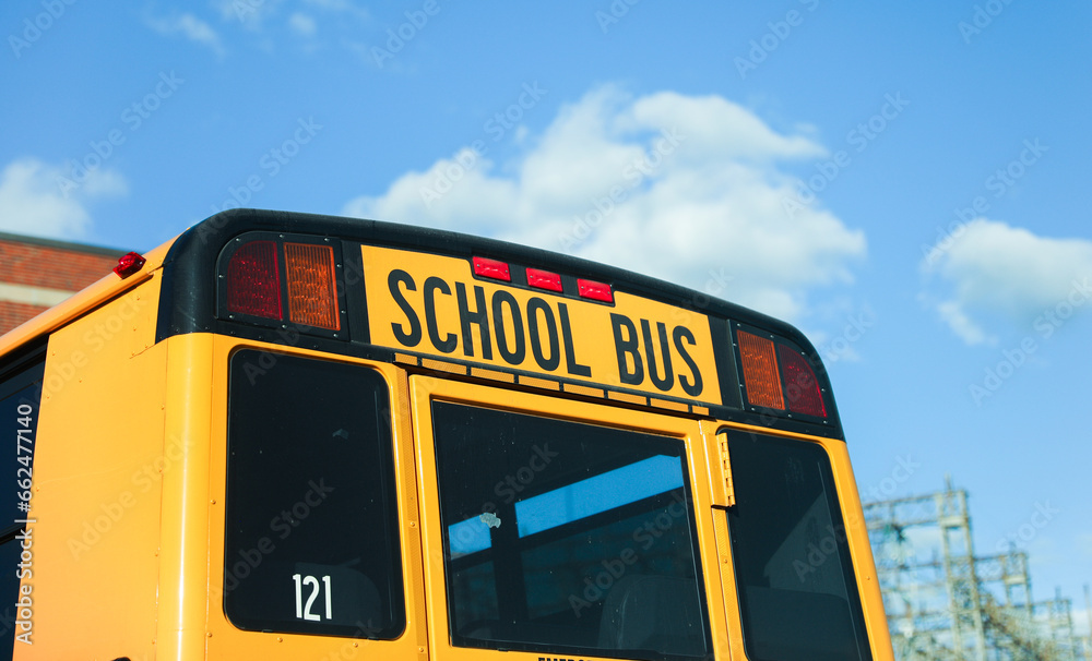 school bus sign on a sunny morning, symbolizing safety, education, and childhood, against a blue sky backdrop