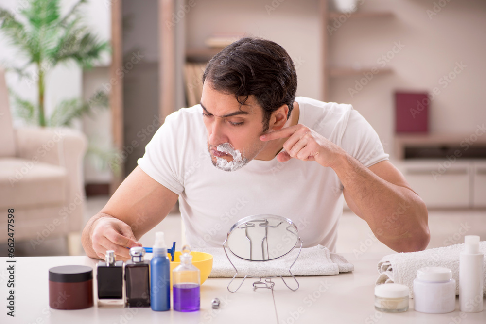 Young man shaving face at home Young man shaving face at home