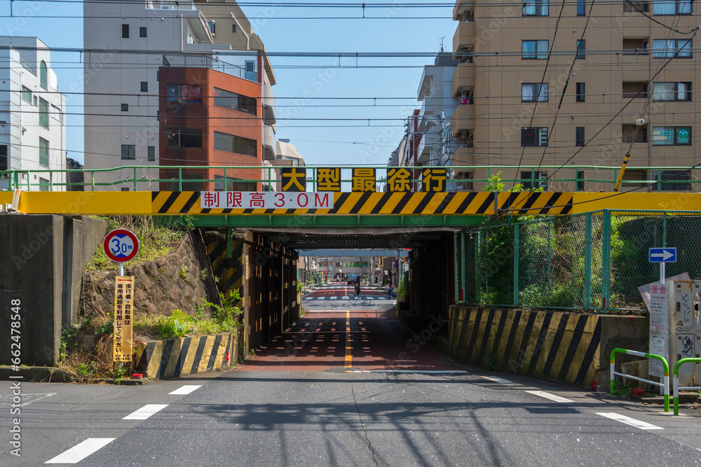 Road tunnel going below railway, with height limit, Tokyo, Japan - obrazy, fototapety, plakaty 