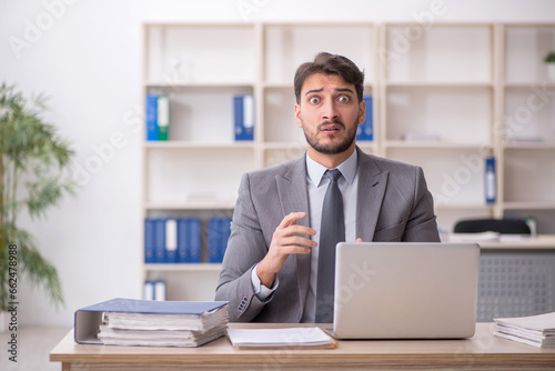 Young male employee working in the office