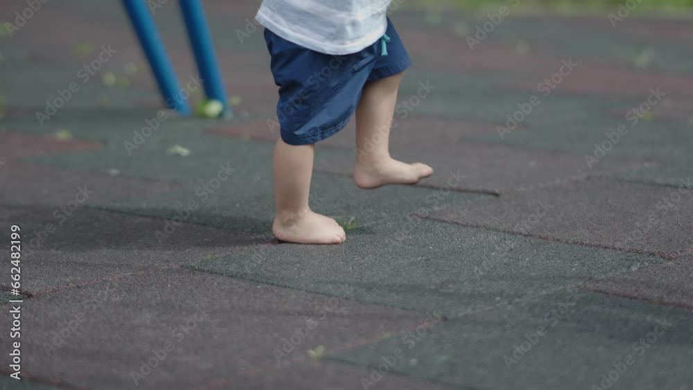 bare legs toddler child runs playground outdoors summer sunny day. pediatrician orthopedist problems feet children concept development healthy skeleton osteopath children's leg foot bad footwear kids bare legs toddler child runs playground outdoors summer sunny day. pediatrician orthopedist problems feet children concept development healthy skeleton osteopath children's leg foot bad footwear kids
