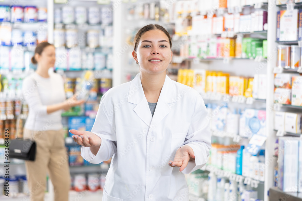 Friendly female pharmacist invites you to visit pharmacy or a store of healing cosmetics