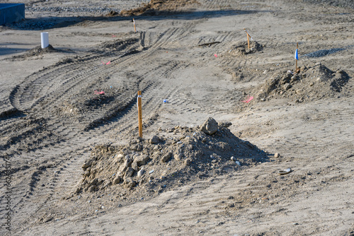 Obraz na plátně Job site preparation, site cleared and leveled, survey stakes in the dirt, new r