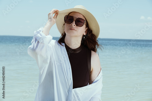 stunning portrait of recognizable woman in summer outfit on a tropical beach