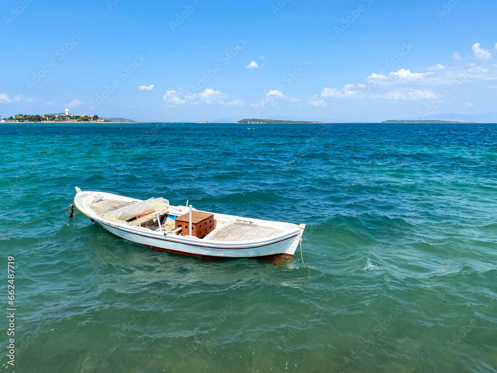 Naklejka premium Small fishing boat in the cost of Aegean sea in Urla, Izmir, Turkey