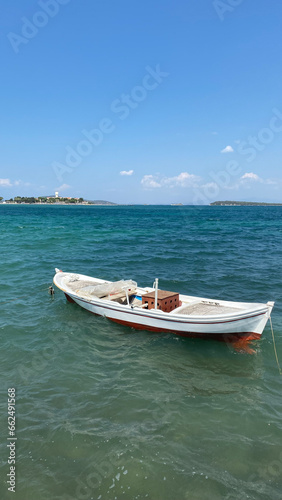 Fishing boat on the azure sea at sunny summer day. © Arda ALTAY