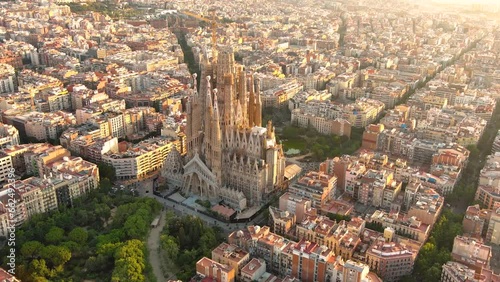 Aerial view of Barcelona city skyline and Sagrada Familia Cathedral at sunrise. Eixample residential famous urban grid. Cityscape with typical urban octagon blocks