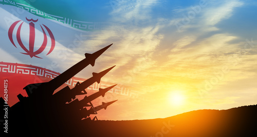The missiles are aimed at the sky at sunset with Iran flag. Bomb, chemical weapons, missile defense, a system of salvo fire.
