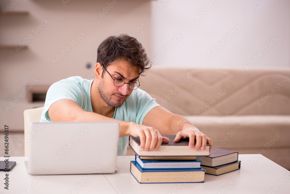 Young male student preparing for exams at home Young male student preparing for exams at home