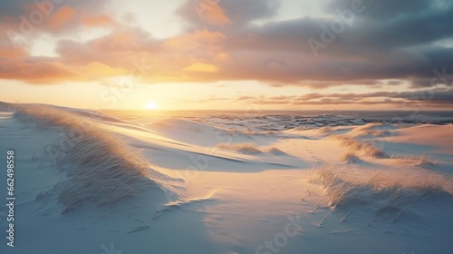 Tranquil winter dunes at sunset, the last rays of the sun casting a warm glow on the snow-covered sandy landscape.