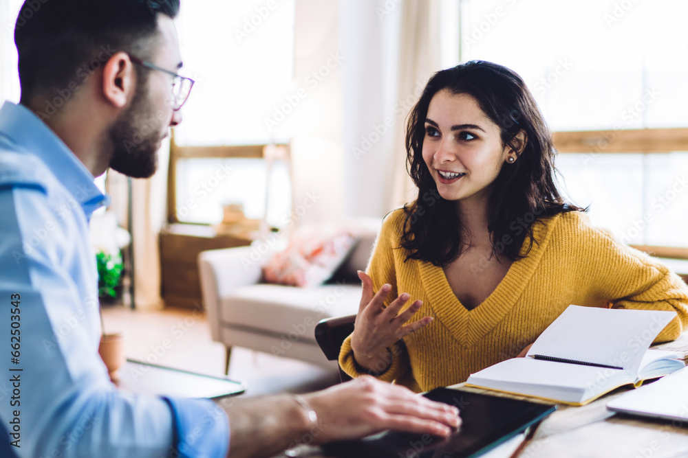 Happy lady talking with man in bright office Happy lady talking with man in bright office