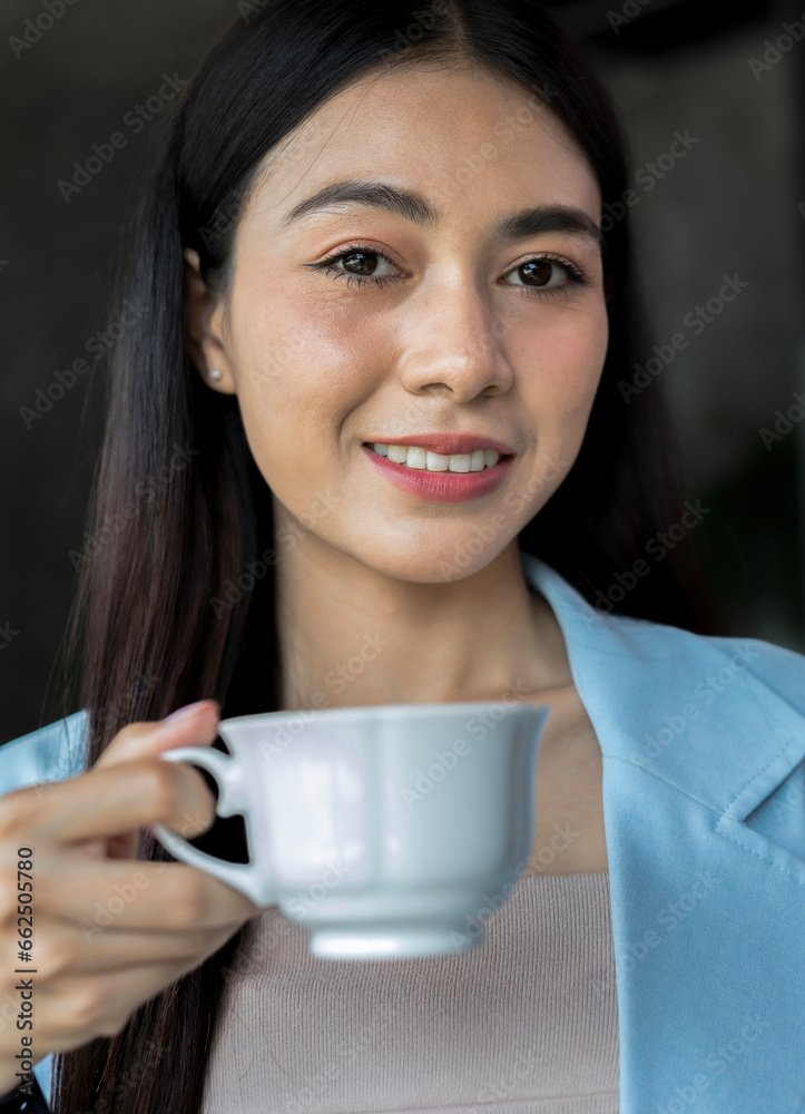 Portrait of a beautiful happy young woman drinking coffee in her home office. Portrait of a beautiful happy young woman drinking coffee in her home office.