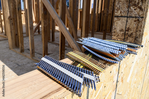 Photos Stacks of framing nails sitting on the windowsill of a house under construction
