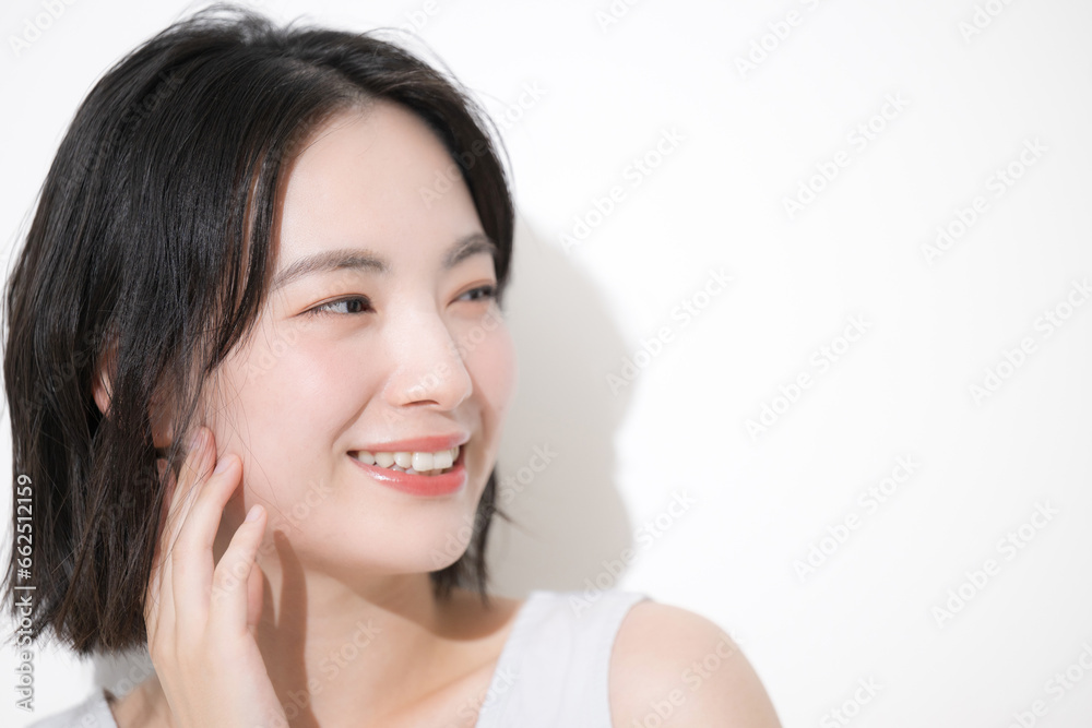 Beauty image of a young Japanese woman touching cheeks Looking up Copy space on the right Beauty image of a young Japanese woman touching cheeks Looking up Copy space on the right