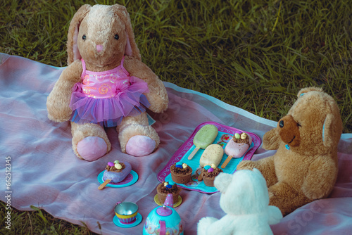 Easter bunny teatime kids play with cupcakes and easter egg sweets photo