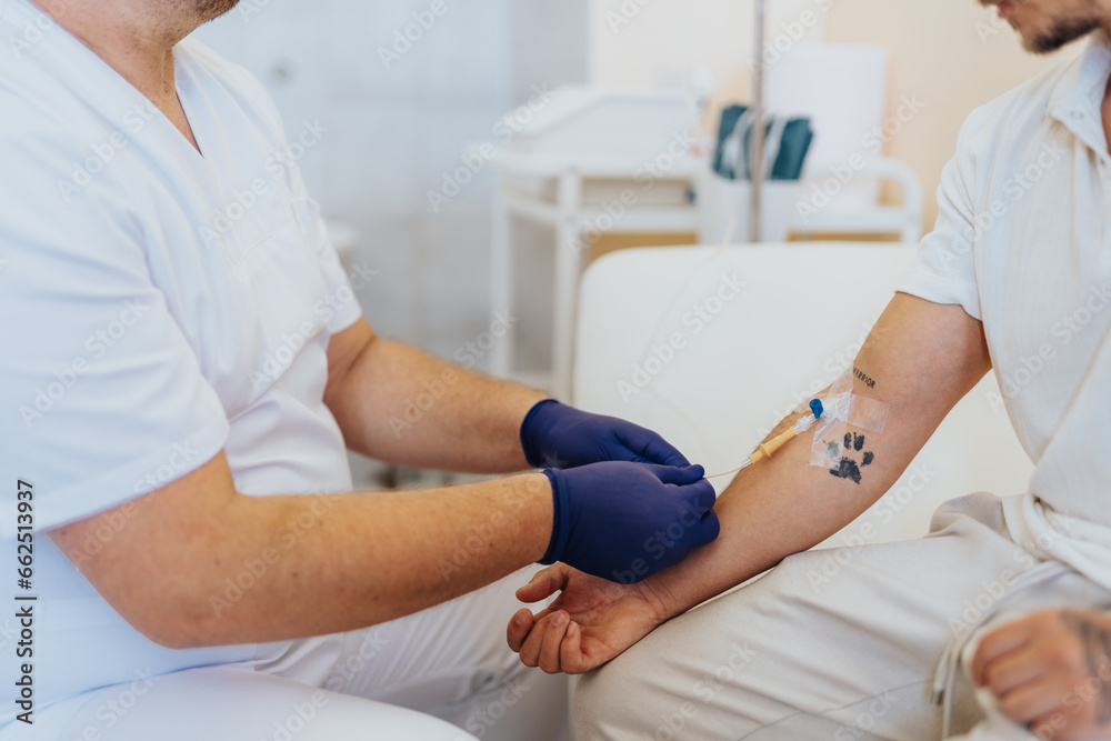 Experienced Specialist Providing Infusion Therapy to Patient in Hospital Room