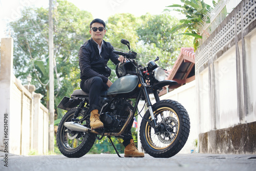 Asian man motorbike in black leather jacket travel rider trip. Handsome Men wear sunglass outdoor lifestyle freedom rider. Men trendy hipster cool person. Young asian man hobby ride with motor bike