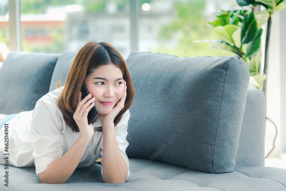 Smiling face asian woman holding smartphone with E-commerce Shopping online website Reading Online Article, Blog, vlog. Young Woman hands holding phone technology lifestyle. Woman using smart phone. Smiling face asian woman holding smartphone with E-commerce Shopping online website Reading Online Article, Blog, vlog. Young Woman hands holding phone technology lifestyle. Woman using smart phone.