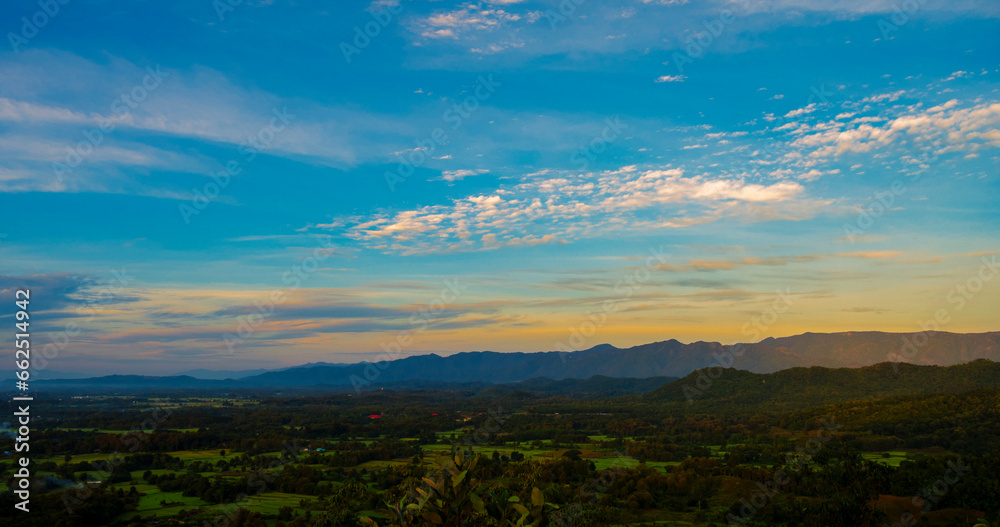 Obraz premium Blue golden sky sunrise dramatic beautiful landscape mountain. Dawn sky gold dusk time cloudscape with sunlight. Dramatic sunset over mountain landscape. Beautiful landscape foggy hills twilight time