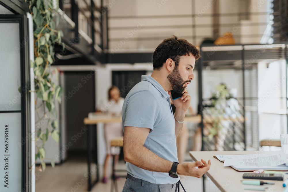 Handsome man discussing with client during phone call. Handsome man discussing with client during phone call.