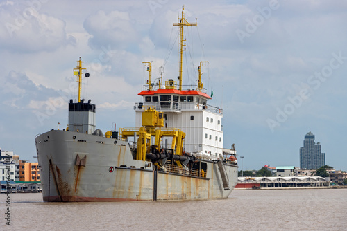 Trailing suction hopper dredger at entrance the Chao Phraya River, Thailand photo