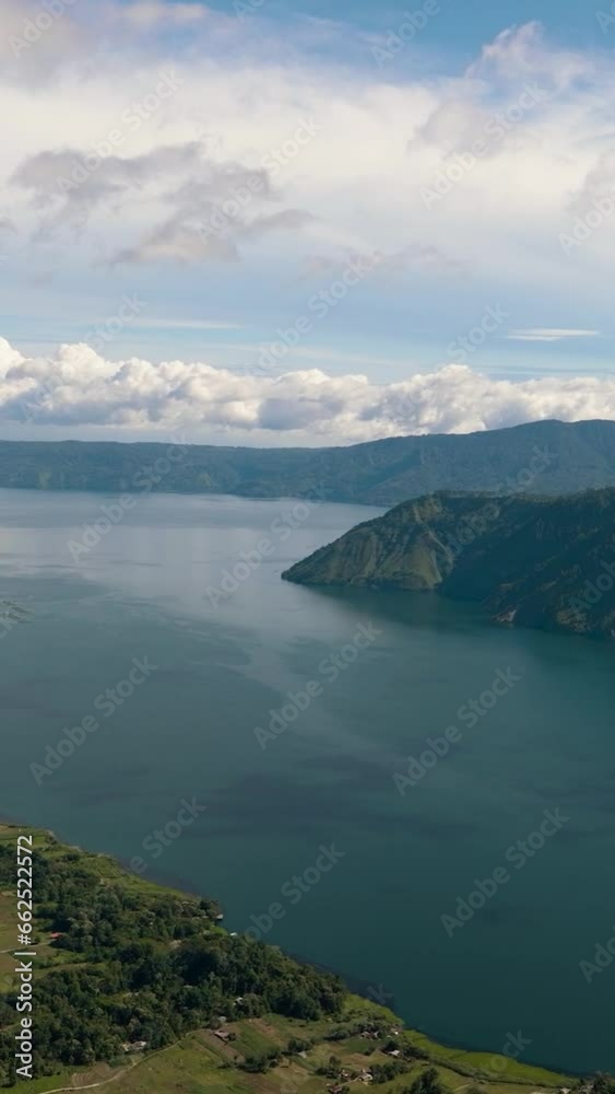 Aerial view of lake Toba and Samosir Island among the mountains in the early morning. Sumatra, Indonesia. Aerial view of lake Toba and Samosir Island among the mountains in the early morning. Sumatra, Indonesia.