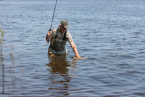 Fishing. One of a series of photos of fishermen catching northern pike.