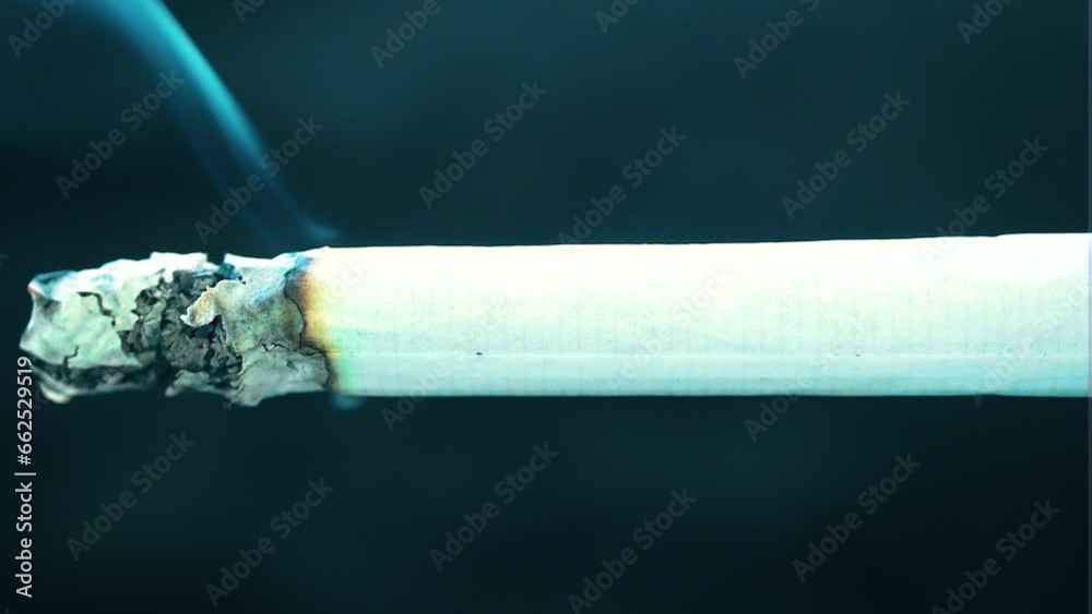almost full isolated burning tailor made cigarette placed across the