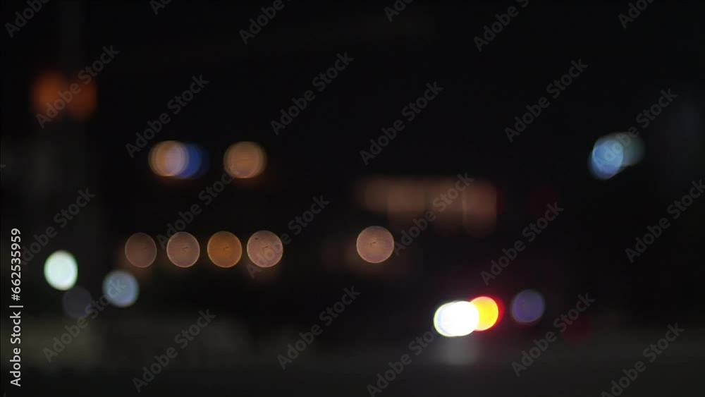 Moving colorful out of focus bokeh of city traffic at night