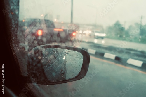 Rain Drops Falling down on background view, High quality video of Rain on Window Sky Drops, Close up Slow Rain, Rainy day, Raining in car mirrors on traffic