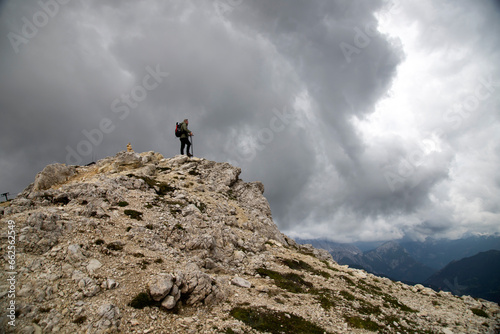 Man traveler traveling alone in breathtaking landscape of Dolomites Mounatains. Travel lifestyle wanderlust adventure concept.