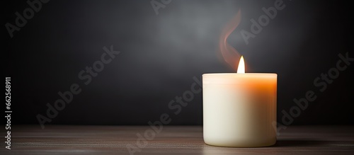 Detailed shot of a lit white candle With copyspace for text