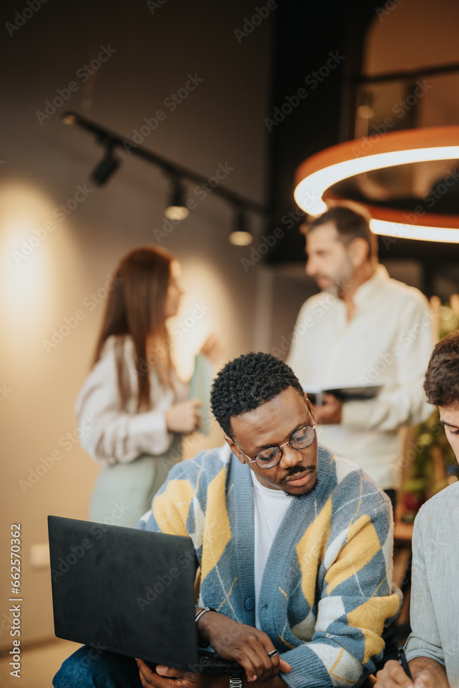 Fototapeta premium Employees discuss new opportunities and analyze market statistics in a modern co-work space. They collaborate, working together towards increased productivity and successful trading strategies.