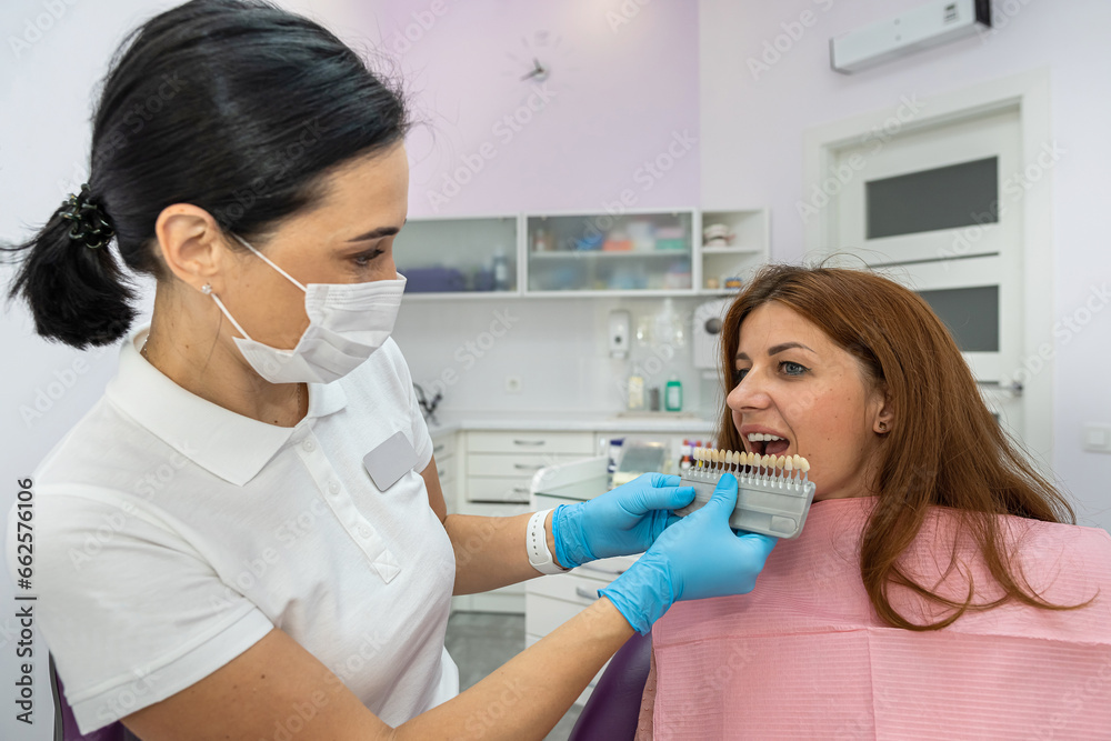 beautiful young woman is having a dental treatment and examination in a dental office. beautiful young woman is having a dental treatment and examination in a dental office.