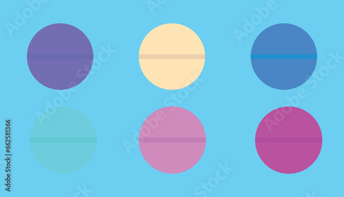set of colored tablets on light blue background. colored medicines