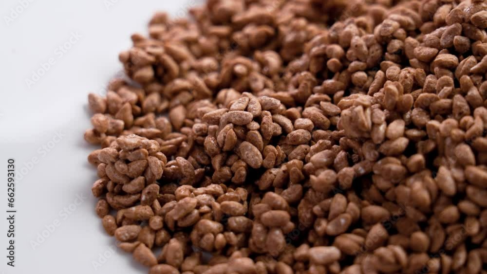 Cereal cocoa crunch choco flakes on a white ceramic dish close up. Dietary healthy food Cereal cocoa crunch choco flakes on a white ceramic dish close up. Dietary healthy food