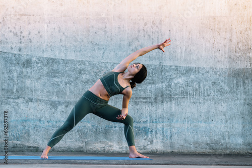 Healthy woman training yoga asana