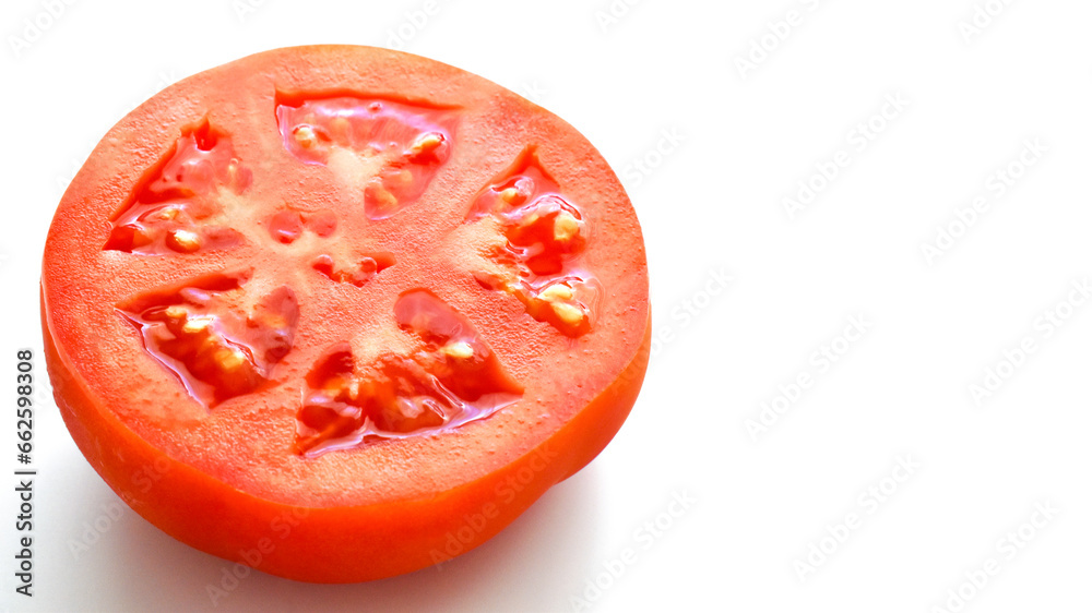 Tomato in half on white background. Healthy and dietary food concept. Copy space is on the right. Tomato in half on white background. Healthy and dietary food concept. Copy space is on the right.